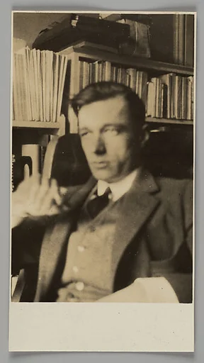 [Self-Portrait, in Front of Bookshelves in Apartment at 448 West 20th Street, New York City]