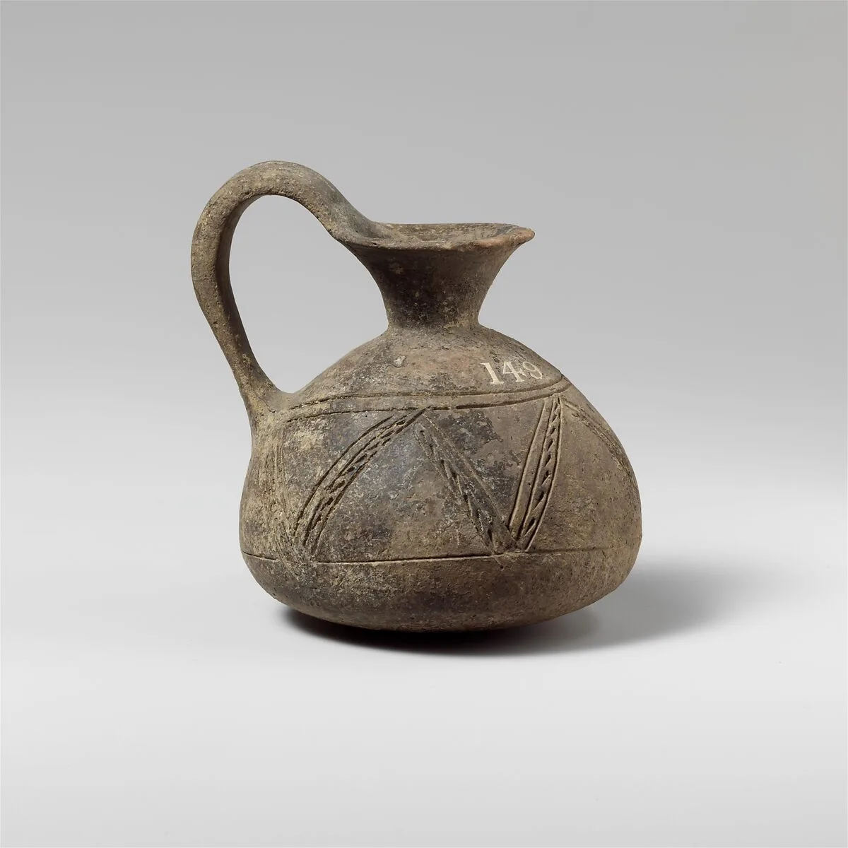 Terracotta jug with incised decoration — Unknown