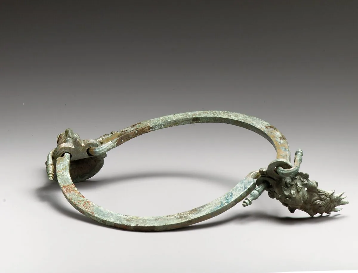 Bronze handle of a situla (pail) with Silenos head attachment and lion head mouthpiece — Unknown