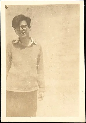 [Woman in Sweater and Horn-Rimmed Glasses]