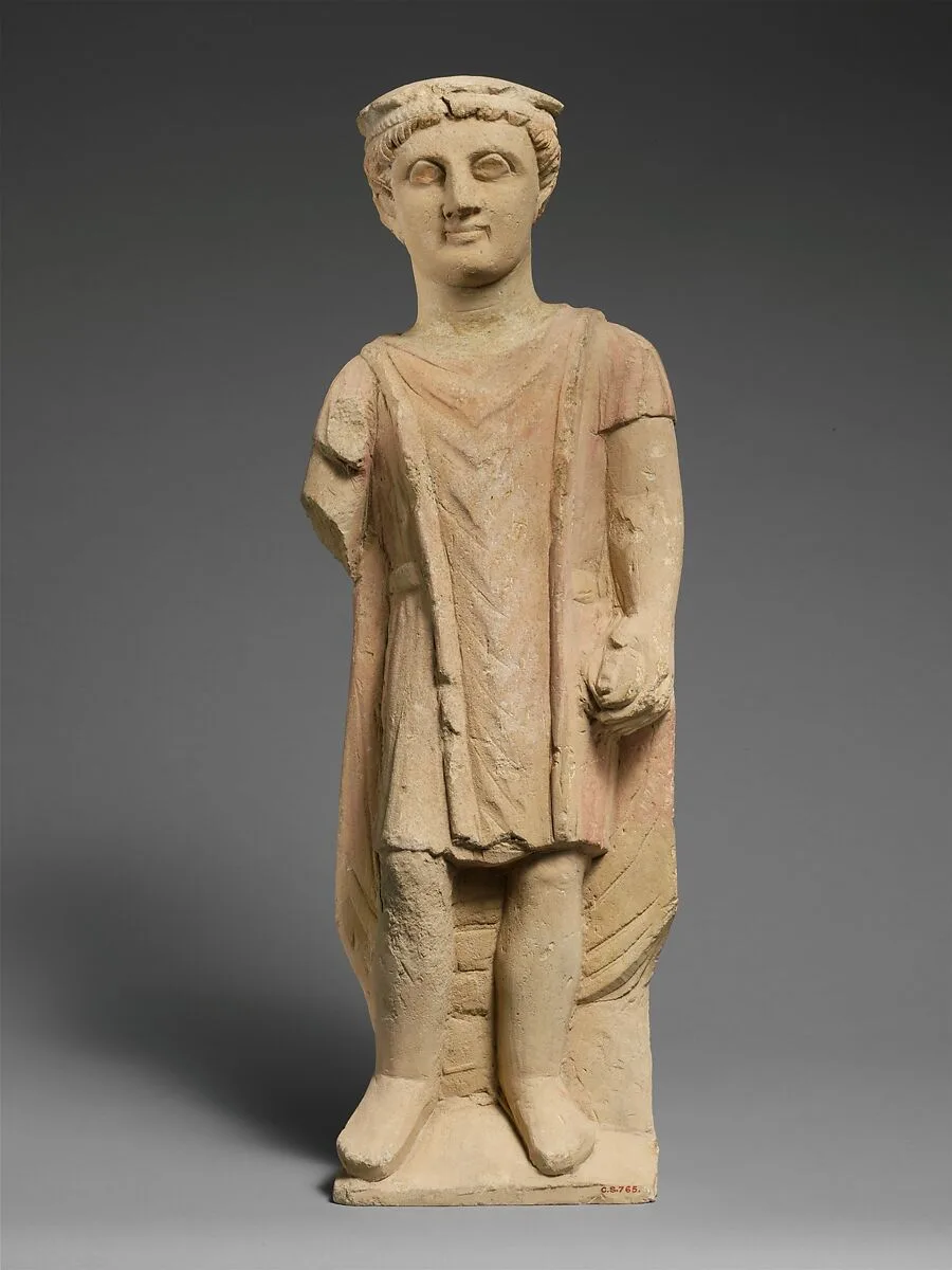 Limestone statuette of a boy holding a pyxis — Unknown