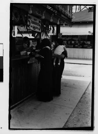 [Two 35mm Film Frames: Women and Children at Amusement Park Food Stand]