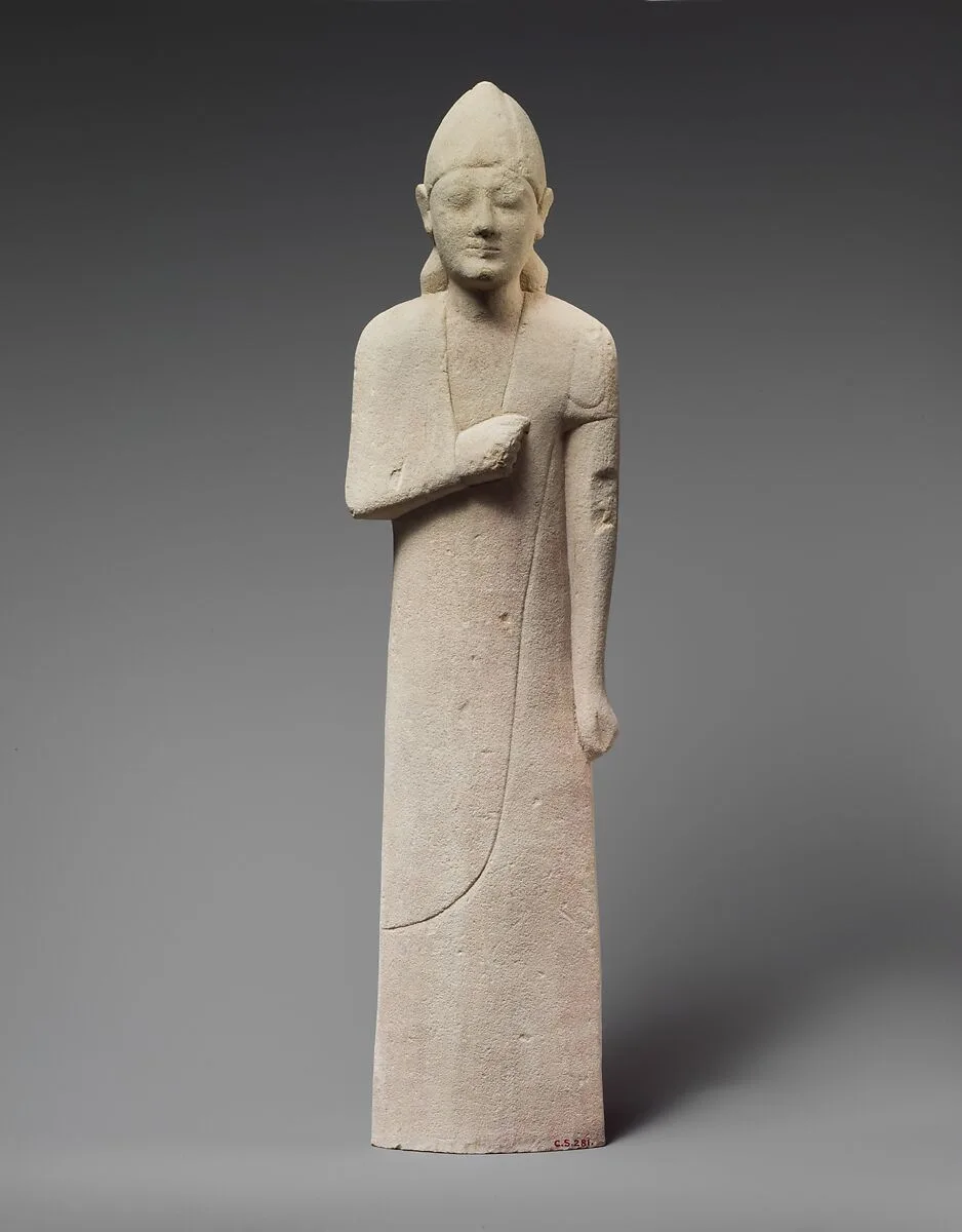 Limestone statuette of a beardless male votary with a conical helmet — Unknown