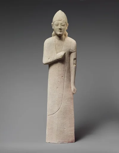 Limestone statuette of a beardless male votary with a conical helmet