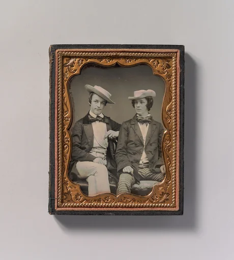 [Two Seated Young Men Wearing Gingham Trousers, Bow Ties, and Brimmed, Soft Hats]
