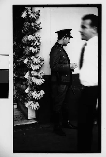 [Policeman in Front of Fruit Stand on Street, Havana]