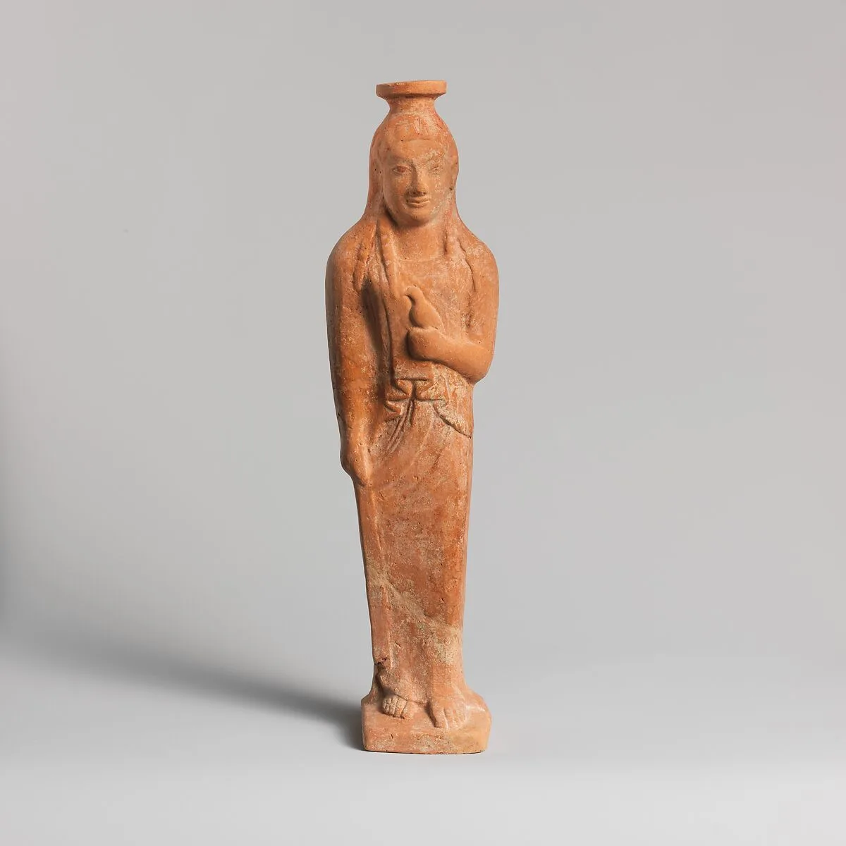 Terracotta vase in the form of a woman holding a bird — Unknown