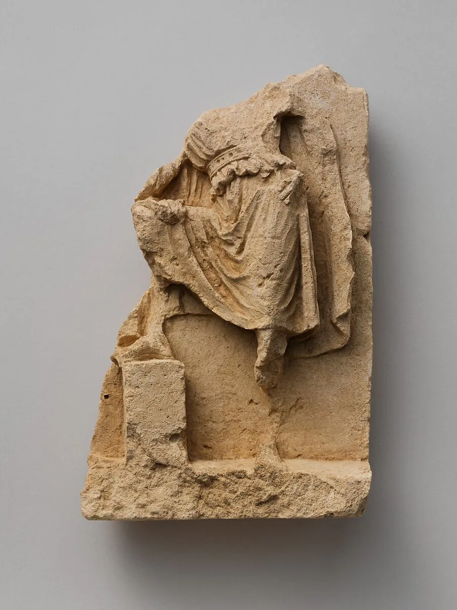 Fragment of a limestone relief with standing figure — Unknown