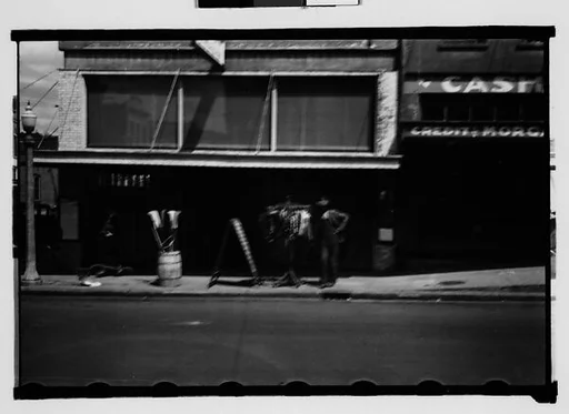 [Man with Clothesrack on Sidewalk, Natchez, Mississippi]