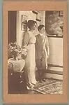 [Woman and Boy, Probably Friends of the Evans Family, Standing Before Staircase]