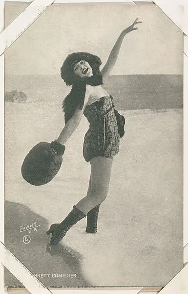 Bathing beauty in costume with fur muff posed on beach from Mack Sennett Comedies Arcade series (W423) — Unknown