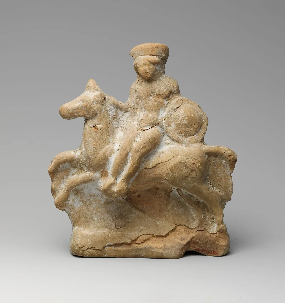 Terracotta statuette of a man seated on a horse — Unknown