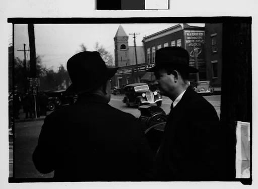[Two Men in Conversation on Street, Milledgeville, Georgia]