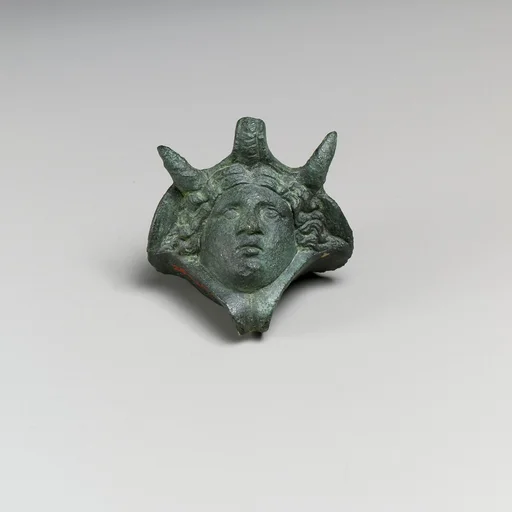 Decorative attachment in the form of a head wearing an elephant headdress