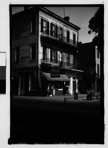 [Cast-Iron Balconied Town House with Ground Floor Drugstore, From Automobile, Savannah, Georgia]