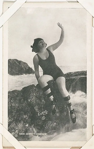 Bathing beauty seated on rocks with arm lifted from Mack Sennett Comedies Arcade series (W423) — Unknown