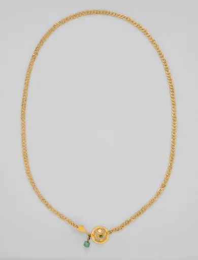 Chain terminating in a leaf motif, and having a raised openwork clasp ornament