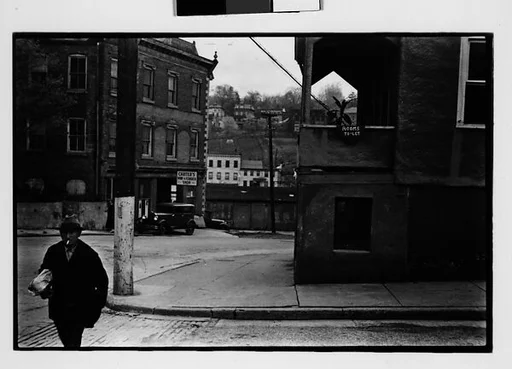 [Two 35mm Film Frames: Street Corner with Pedestrian in Foreground, Woman on Balcony, Ossining, New York]