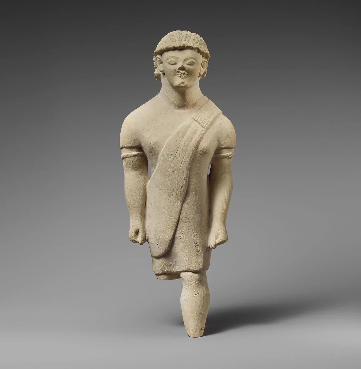 Limestone statuette of a beardless male votary in Greek dress — Unknown