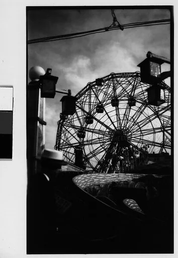 ["Wonder Wheel" and "Virginia Reel" Rides with Hanging Lamps and Cables, Coney Island, New York]
