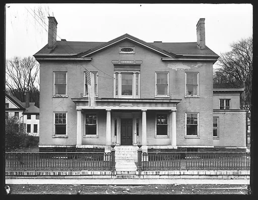 [Greek Revival House with Placard "1834" and American Flag]
