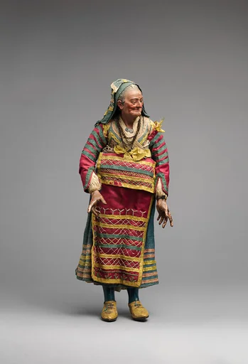 Old woman in blue dress and various color apron