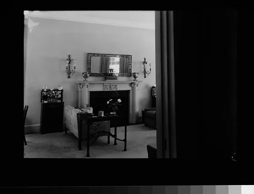 [Living Room Interior Showing Fireplace, Sofa, and Table]