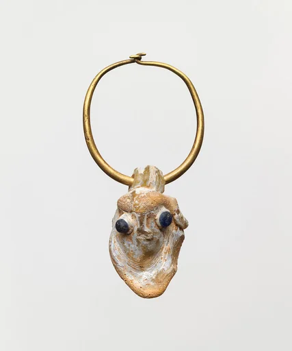 Gold earring with a glass pendant in the form of a demonic mask