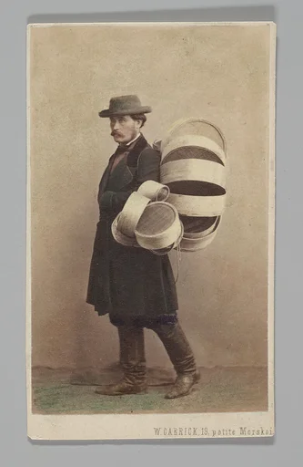 [Studio Portrait: Man in Coat Carrying Baskets, St. Petersburg]
