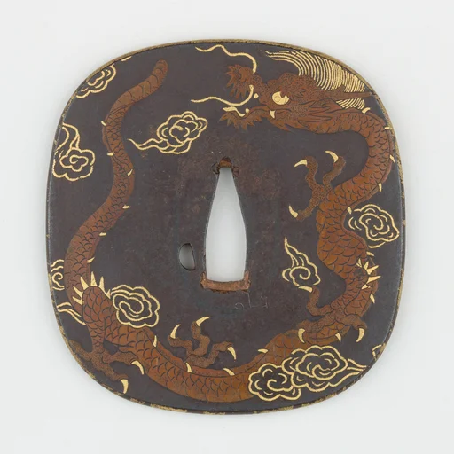 Sword Guard (<i>Tsuba</i>) Depicting Dragon and Paulownia Leaves With Tendrils (龍と桐唐草図鐔)