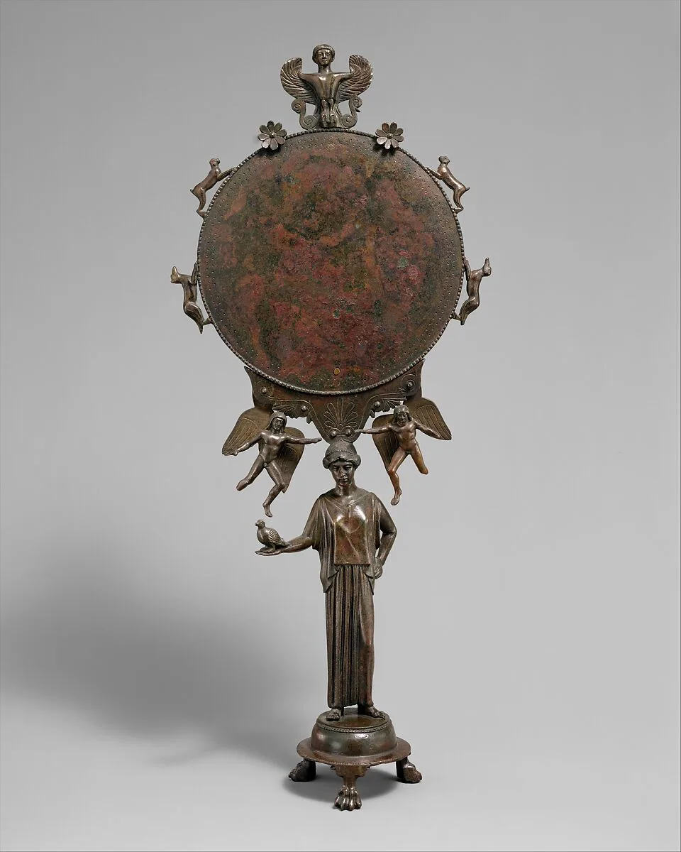 Bronze mirror with a support in the form of a draped woman — Unknown