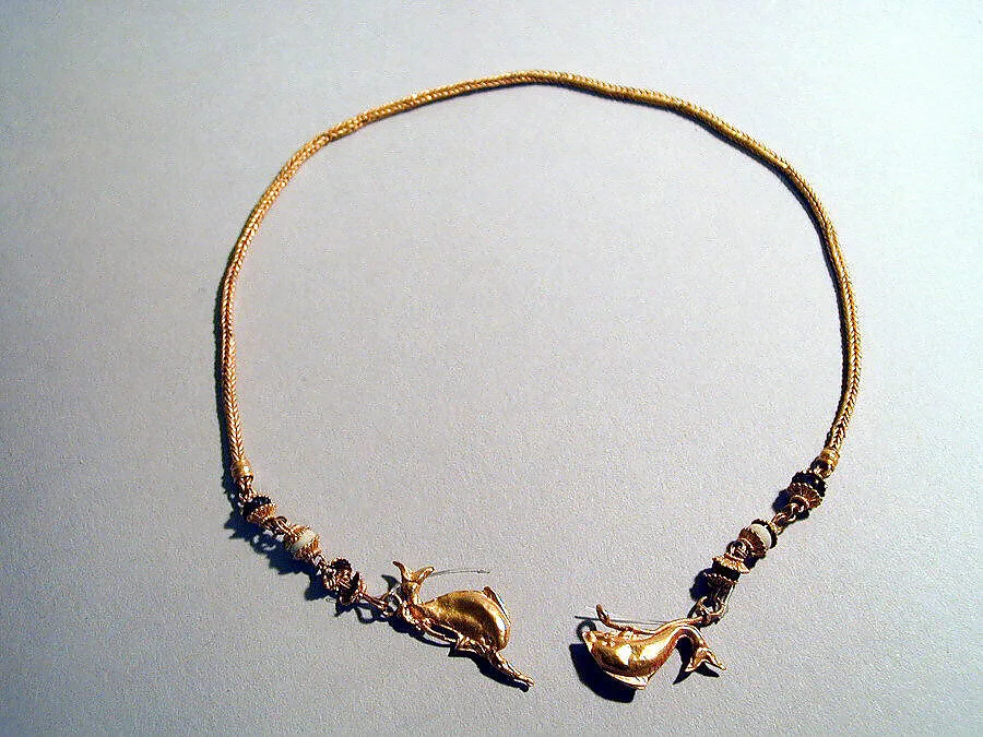Gold chain with dolphins and glass beads — Unknown