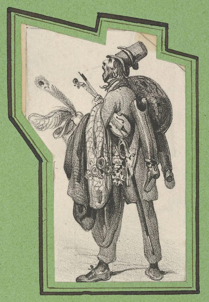 Man wearing two hats and holding boots, jackets and a violin — Victor Adam