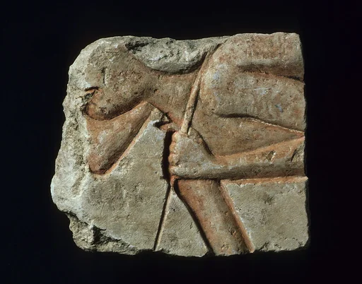 Relief with a stooped workman