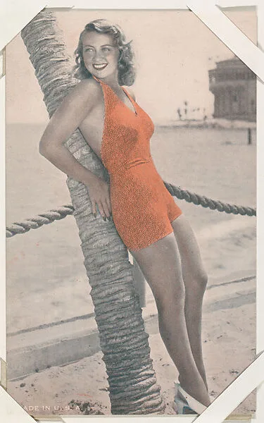 Actress leaning on palm tree (W423) — Unknown