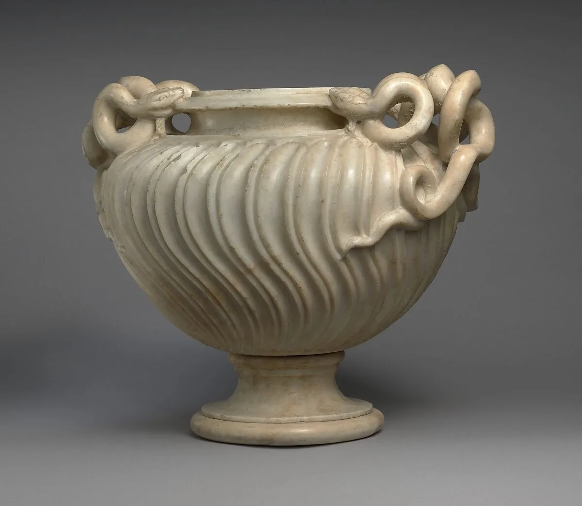 Marble strigilated vase with snake handles — Unknown