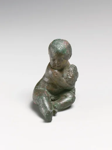 Bronze statuette of a child with a bunch of grapes