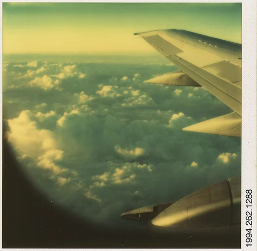 [Wing and Clouds From Plane Window]