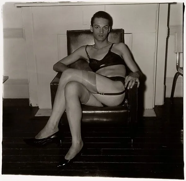 Seated man in a bra and stockings, N.Y.C. — Diane Arbus
