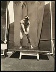 [Male Model Posed in Sunlight on Rooftop Stage]
