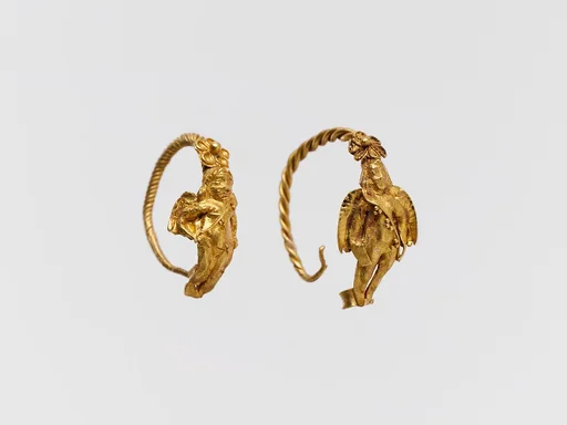 Gold earring with winged figure