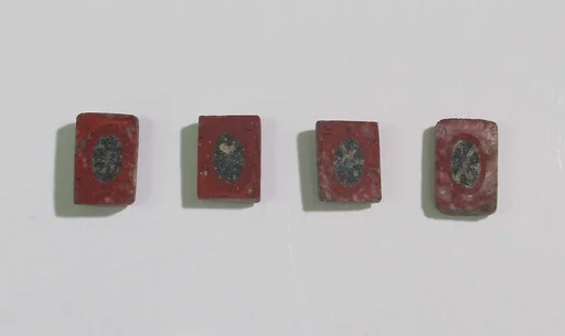 Inlay elements from shrine: red with black oval