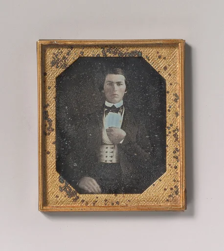 [Young Man with Hand Tucked in Vest]