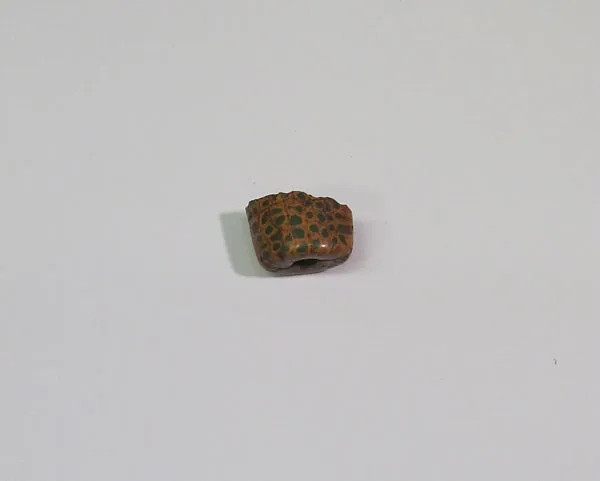 Part of orange and green conical bead — Unknown