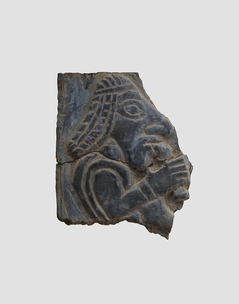 Furniture plaque carved in relief with man holding vessel to his mouth — Unknown