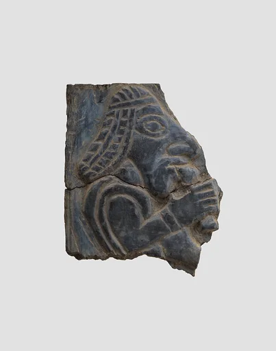 Furniture plaque carved in relief with man holding vessel to his mouth