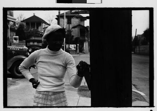 [Five 35mm Film Frames: Woman in Filling Station Lot, Man on Sidewalk in Front of Movie Poster, Vicksburg or New Orleans]