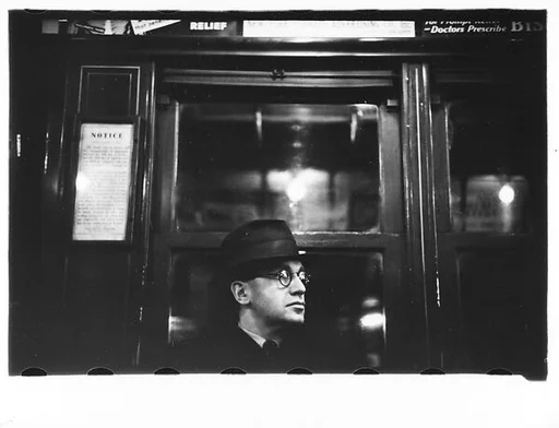 [Five 35mm Film Frames: Subway Passengers, New York City: Man in Hat and Eyeglasses, Young Woman in Eyeglasses and Coat, Man in Hat Beneath Map, Subway Newsstand Vendor in Front of Magazine Display]