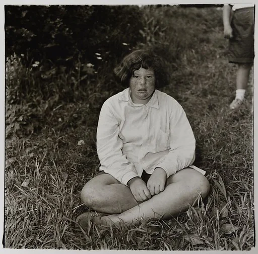 Girl sitting in the grass at Camp Lakecrest, Dutchess County, N.Y.
