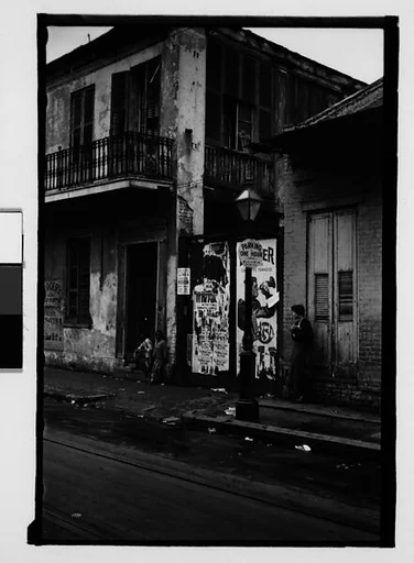 [Shuttered House Façade with People on Balconies in French Quarter, New Orleans, Louisiana]